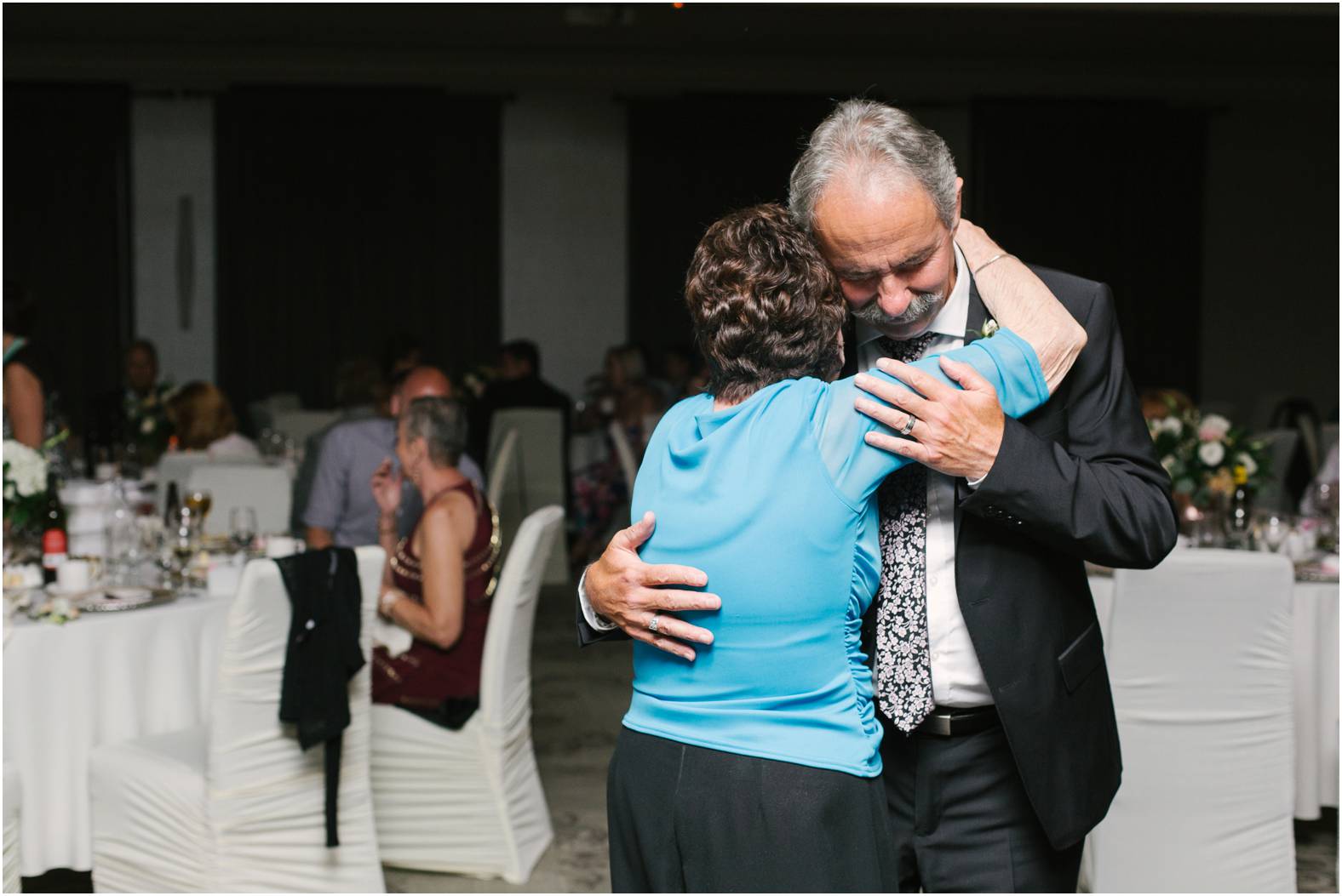 Father of the groom dances with grandmother in emotional moment at summer wedding reception