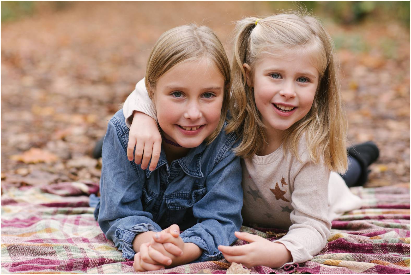 Two sisters pose during fall mini session