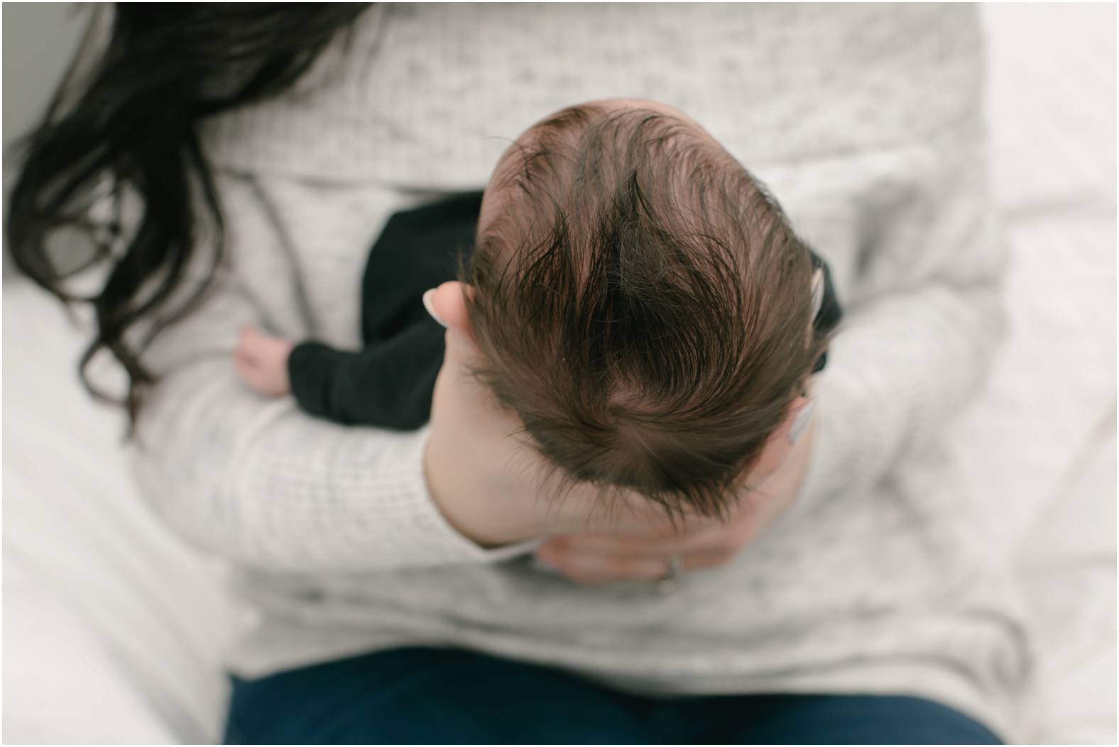 Detail of baby boy with dark hair.